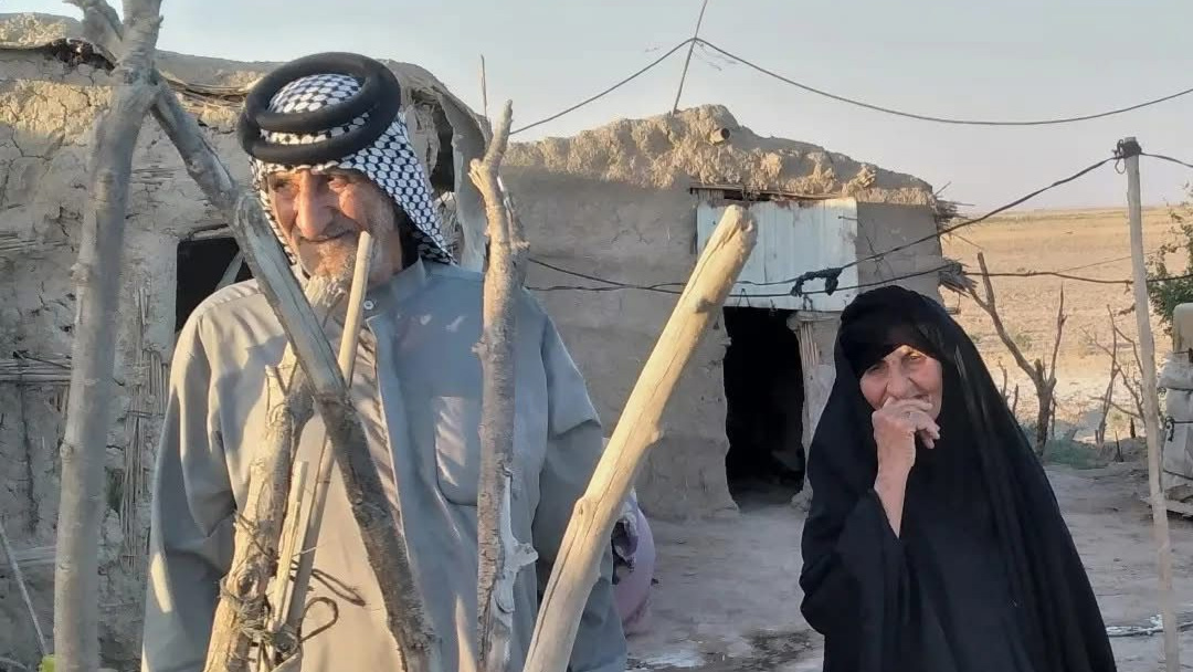 Um Qasim and Abu Qasim are pictured at their home in the Hawizeh Marshes in 2022, shortly before the devastation of their buffalo herd forced them to leave (Supplied photo)