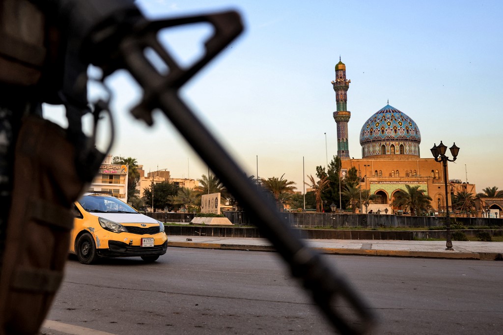 The muzzle of an assault rifle carried by an Iraqi police officer is seen in Baghdad on 9 March 2023 (AFP)