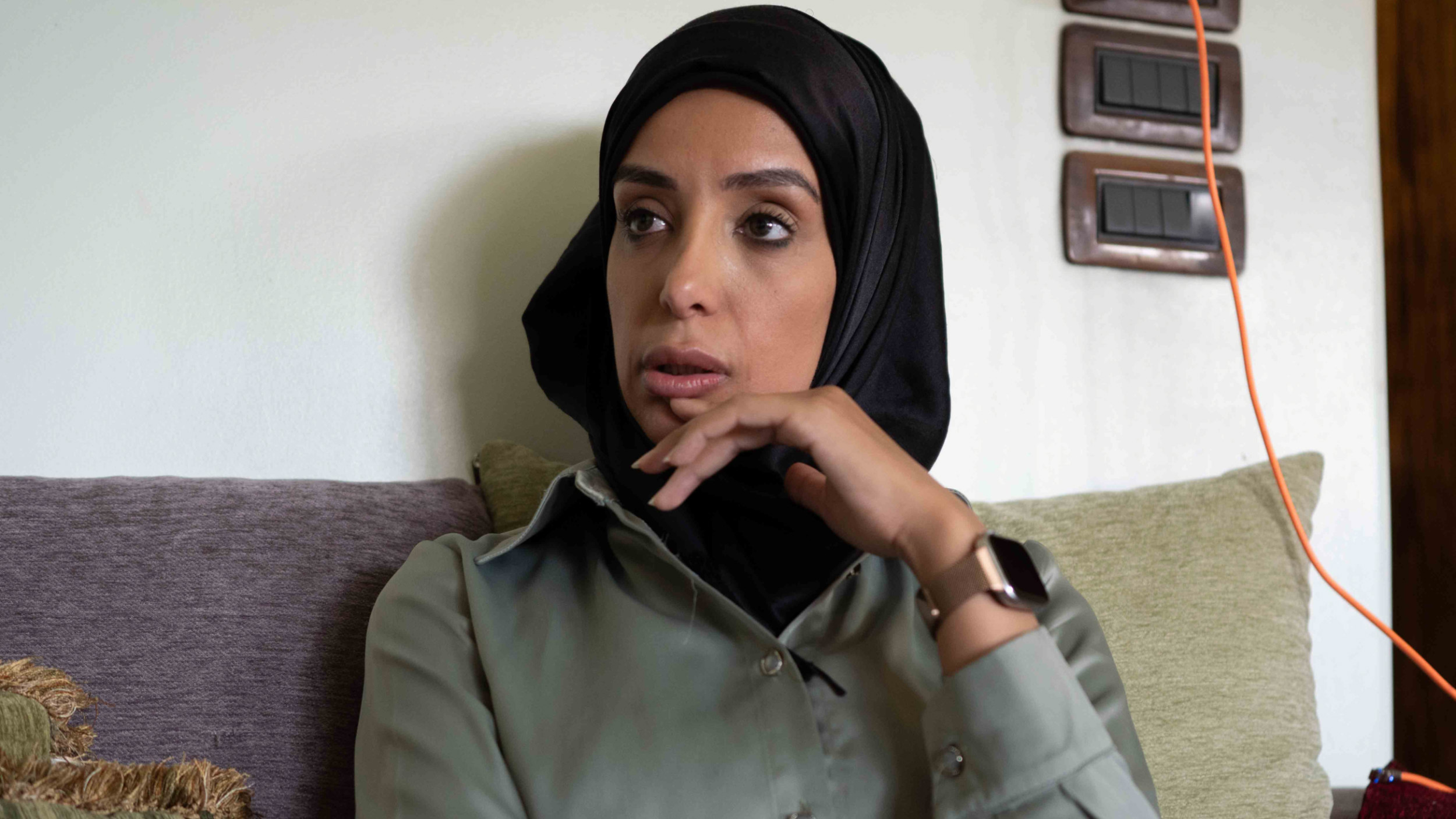 Adel al-Natour's daughter Israa speaks to Middle East Eye in the family's home in Damascu (Natacha Danon/MEE)
