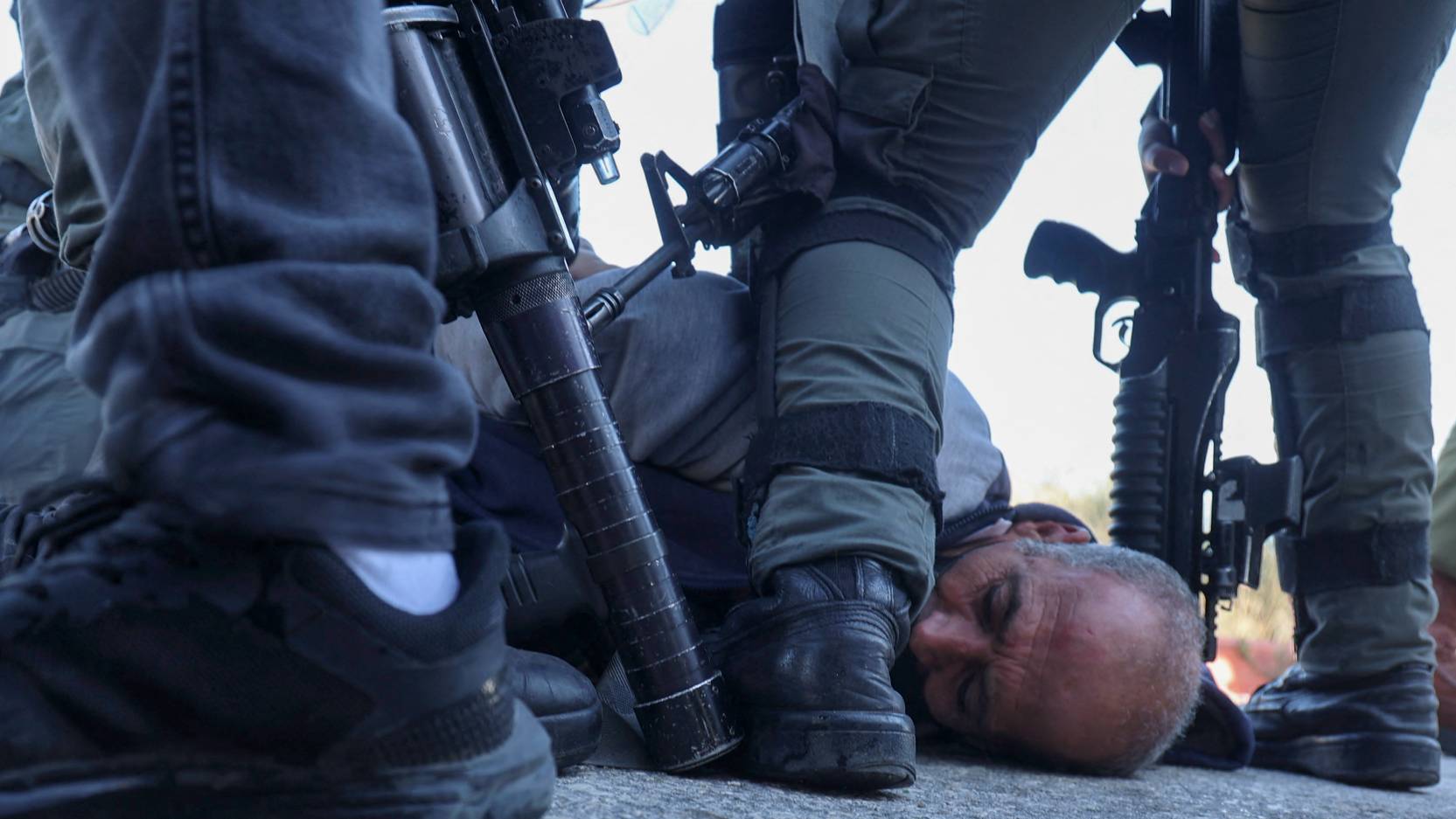 Israeli occupation army detains a Palestinian protester against evacuations in Sheikh Jarrah neighbourhood in occupied East Jerusalem, 2021 (AFP)