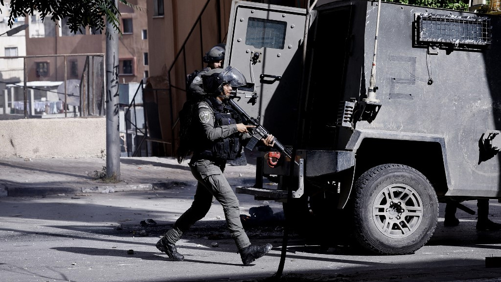 Israeli soldiers raid the Balata camp for Palestinian refugees in the occupied West Bank on 23 November 2023 (AFP)