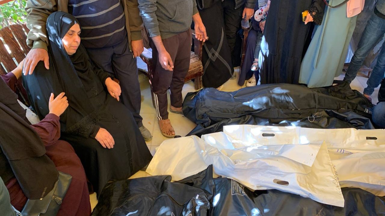 Majedeh Abu Roos (left) mourns the loss of her daughter and grandchildren following deadly strikes on the al-Mawasi humanitarian zone (MEE/Ahmed Aziz)