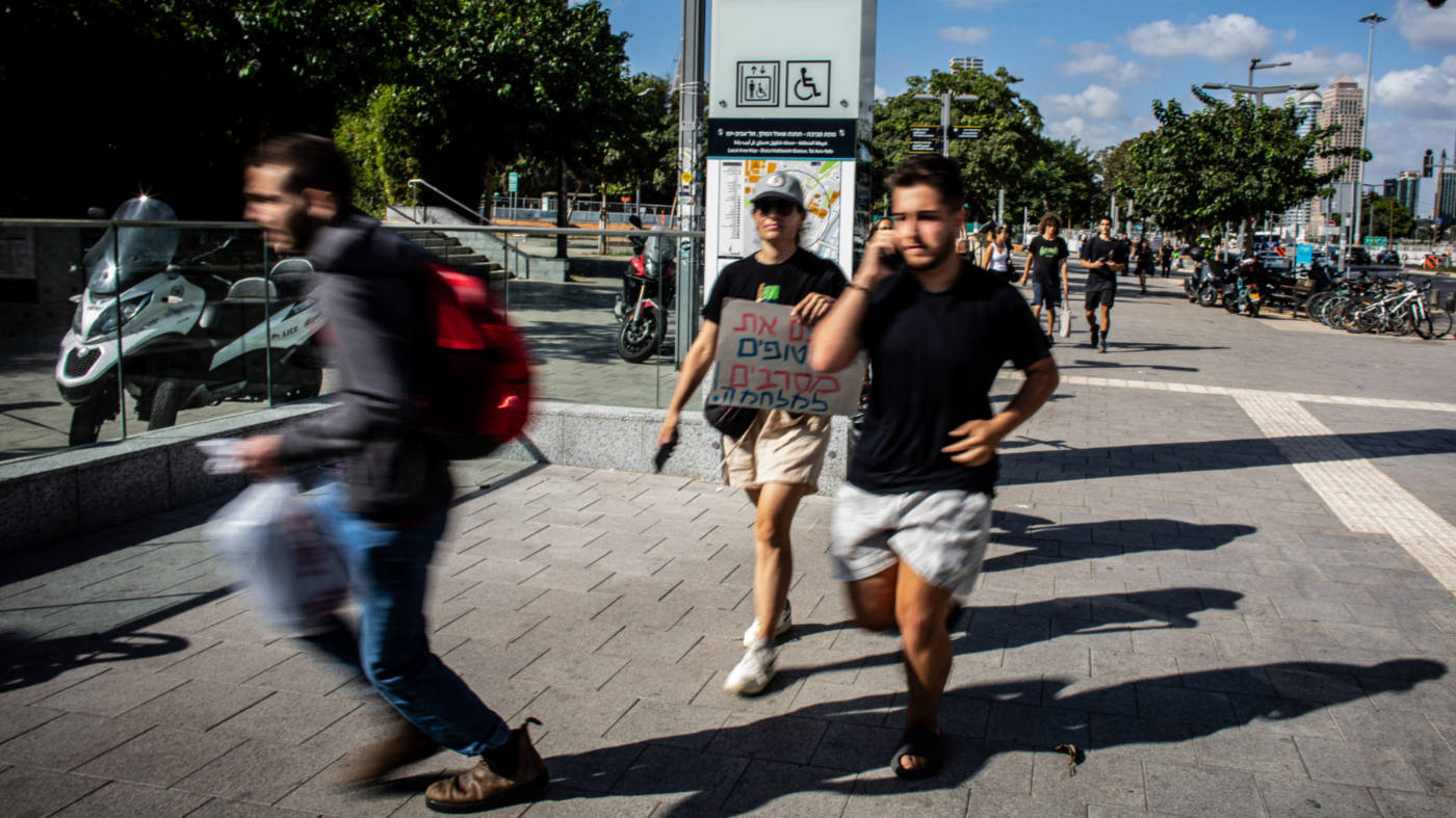 August 2025: People in Tel Aviv run for shelter during a Houthi missile attack after a demonstration (Reuters)