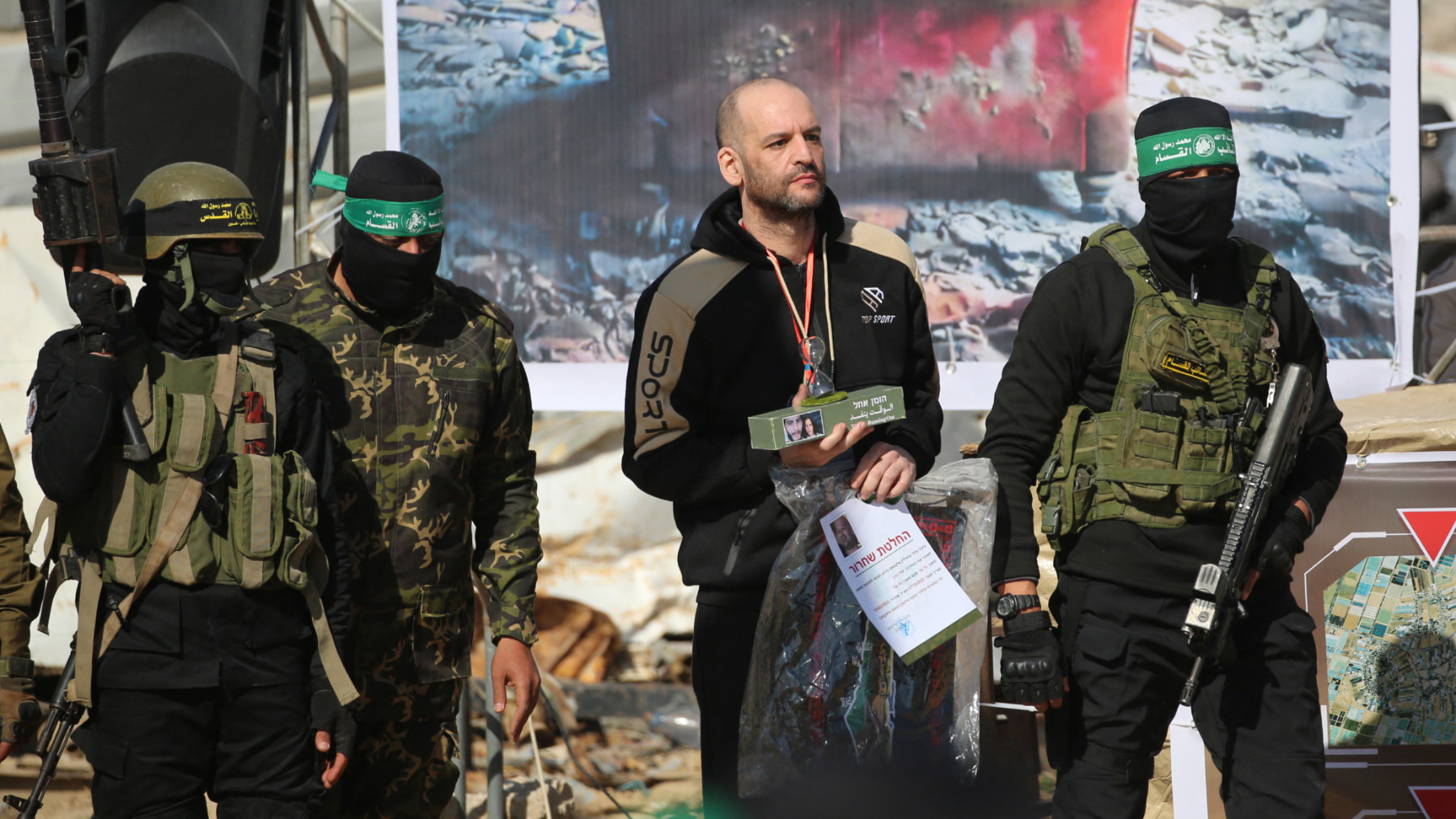 Israeli captive Yair Horn (C) during his handover to a Red Cross team along with two other Israeli captives in Khan Younis in the southern Gaza Strip on 15 February 2025 (AFP)