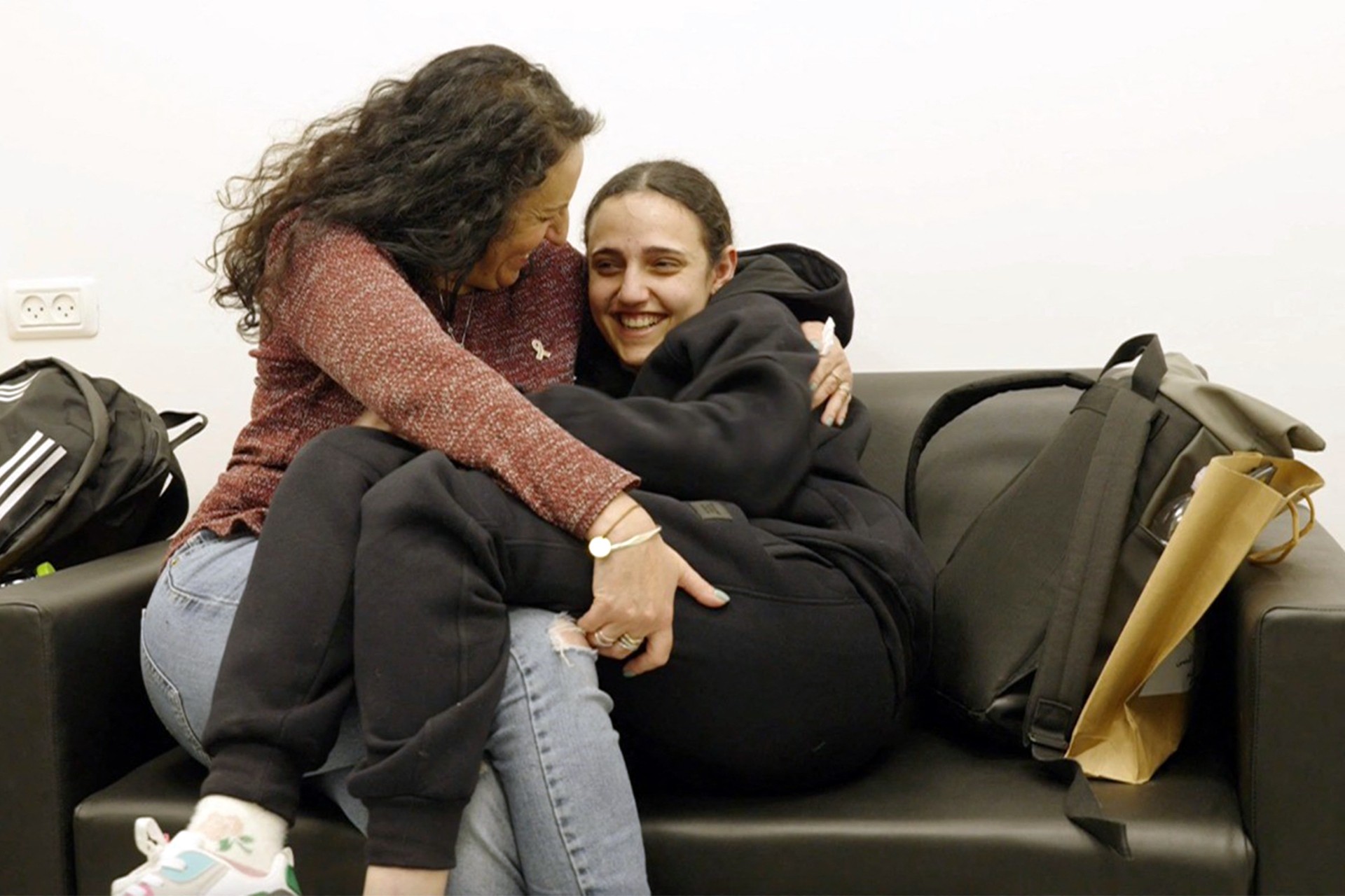 Romi Gonen reunited with her mother Merav on 19 January 2025, after being held in Gaza for 15 months (AFP/Israeli army)
