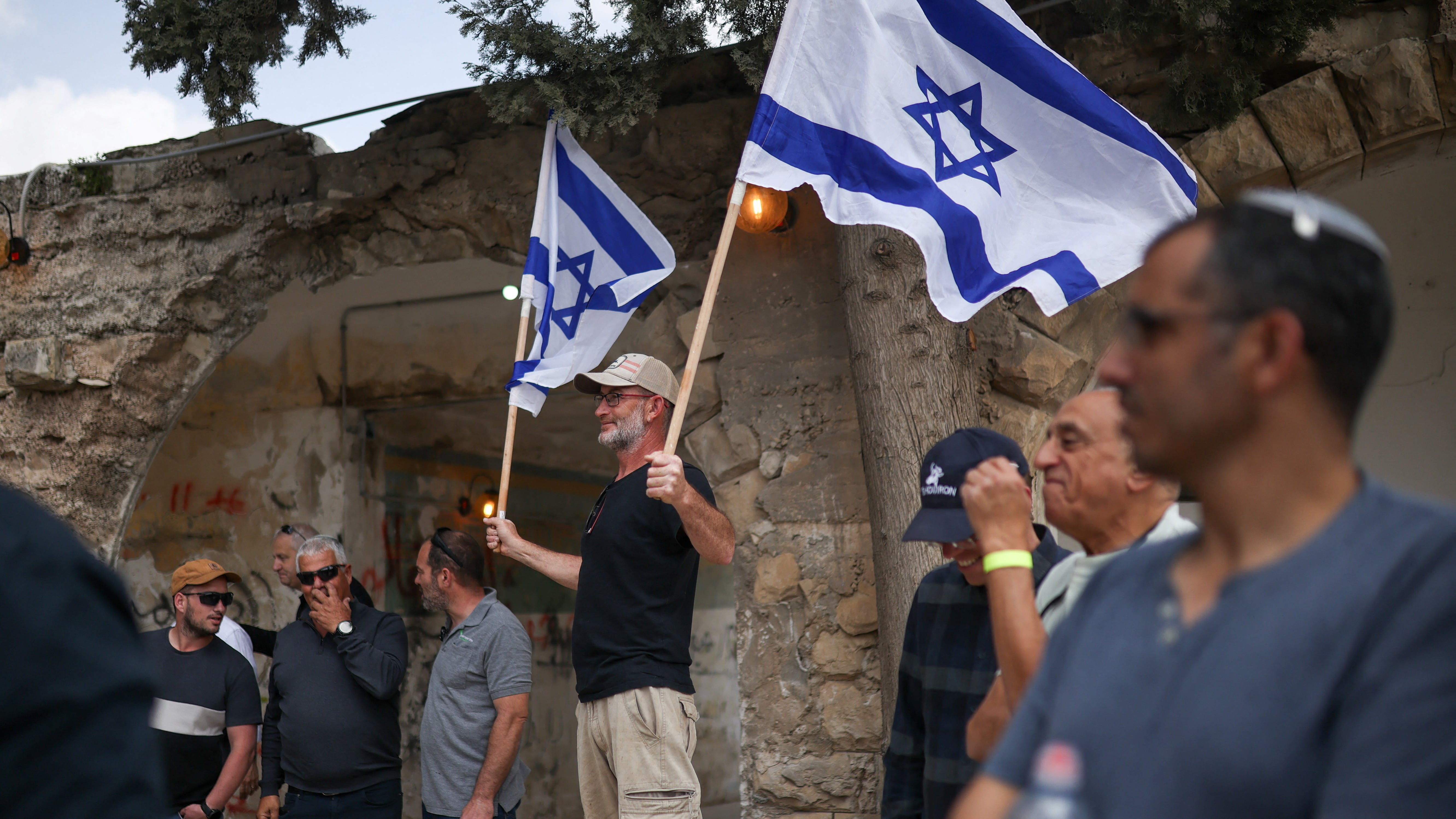 Israeli settlers celebrate the re-establishment of a settlement in Sanur, southwest Jenin, occupied West Bank ()