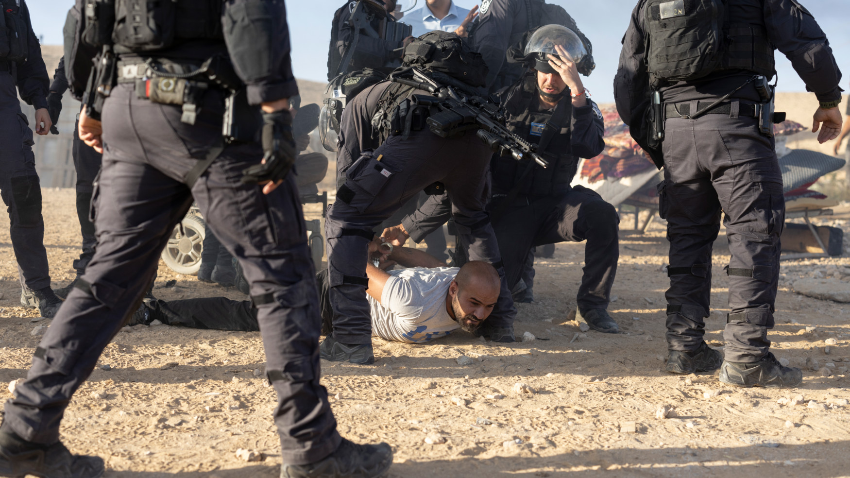 Israeli police attack a resident of the village protesting the demolition of his home in al-Sir village on 17 September 2025 (Oren Zif/MEE)