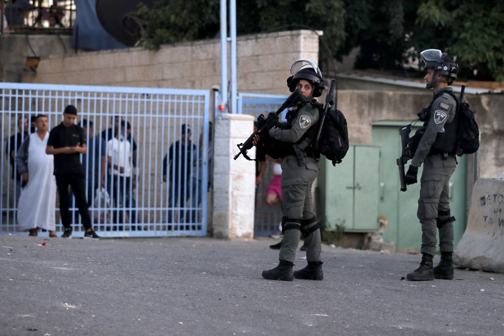 Israeli border guards stand at attention in the east Jerusalem neighbourhood of Sheikh Jarrah on 14 May 2021.