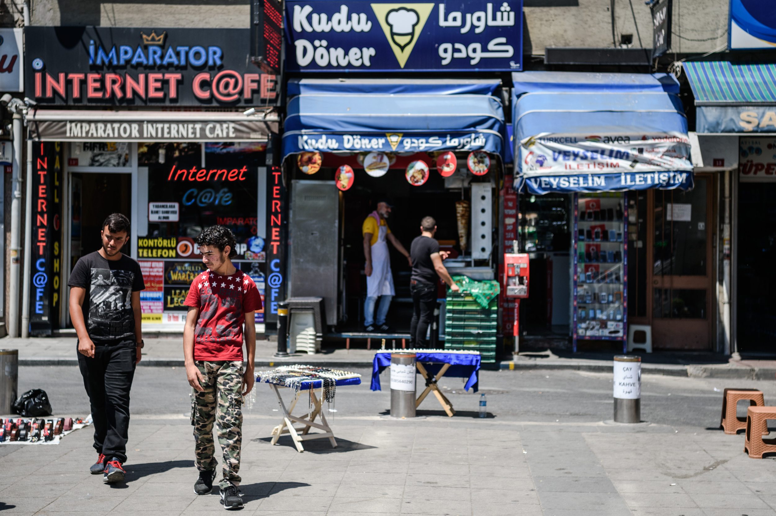 Men walk in the Fatih neighbourhood of Istanbul, home to thousands of Syrian refugees, in July 2016 (AFP)