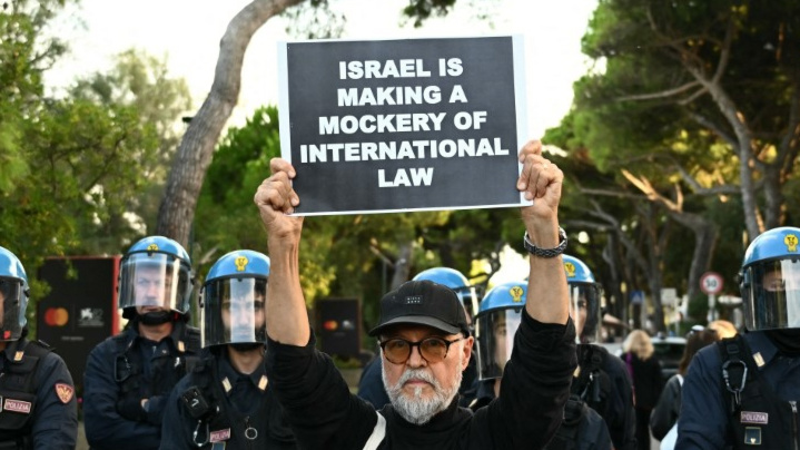 A man stands in front of police as part of a demonstration in support of Gaza at Venice Lido, Italy, on 30 August 2025 (Stefano Rellandini/AFP)