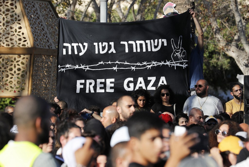 Palestinians protest against Israel’s Gaza offensive in Jaffa on 18 May 2021 (AFP)