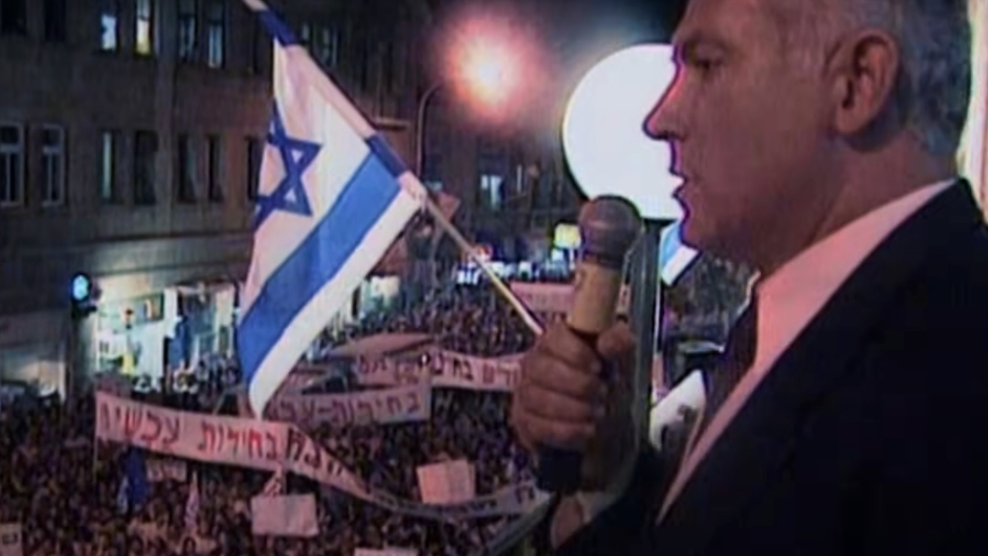 From a balcony, Benjamin Netanyahu addresses a protest in Jerusalem in 1995 against Yitzhak Rabin and the Oslo Accords (screengrab)