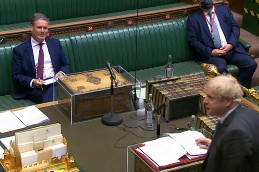 British Prime Minister Boris Johnson speaks as Starmer listens at the House of Commons in London on 28 April 2021 (AFP/PRU)