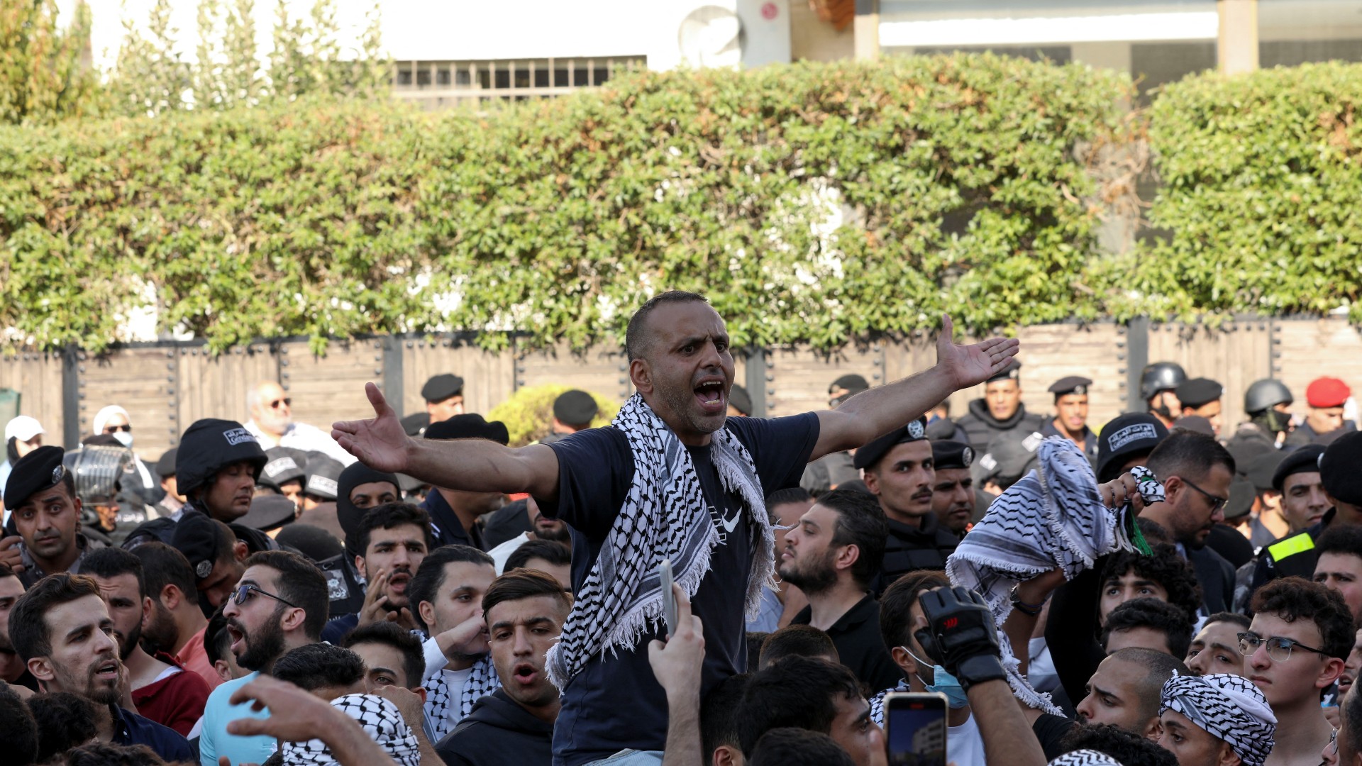 People take part in a protest in Amman on 18 October after an Israeli air strike killed hundreds of Palestinians at Al-Ahli hospital in Gaza (Reuters)