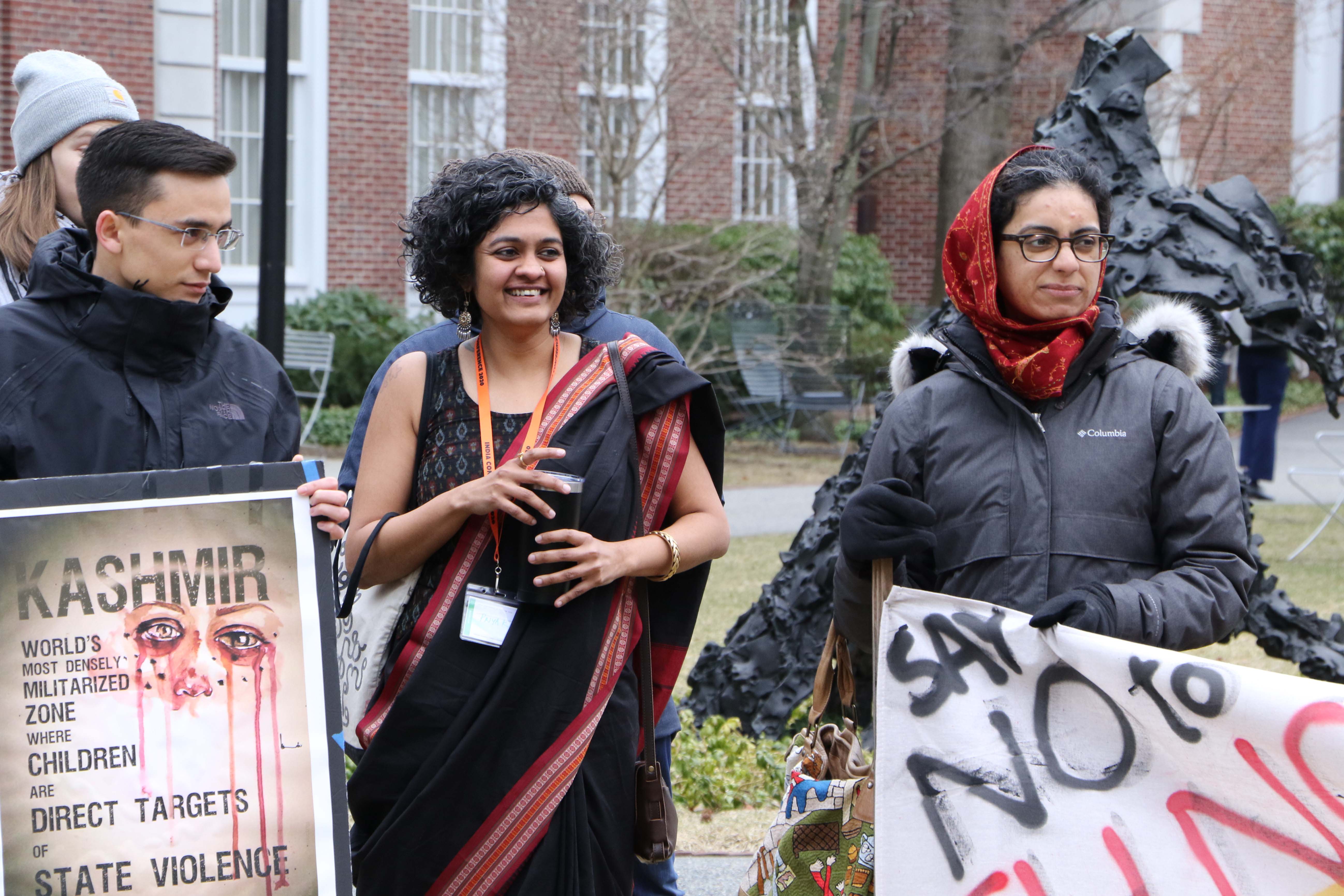 A conference participant stands alongside demonstrators.
