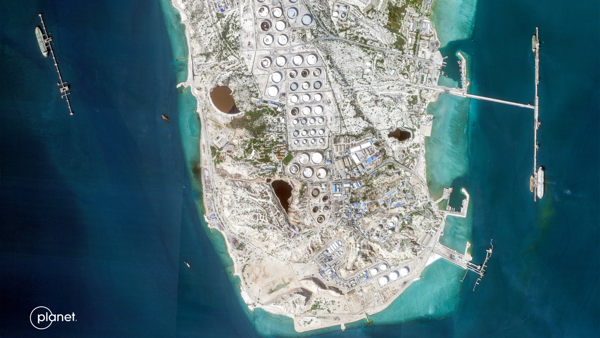 This handout satellite image taken by 2026 Planet Labs PBC shows a view of Iran's Kharg Island, which hosts the country’s main crude export terminal (AFP/2026 Planet Labs PBC)
