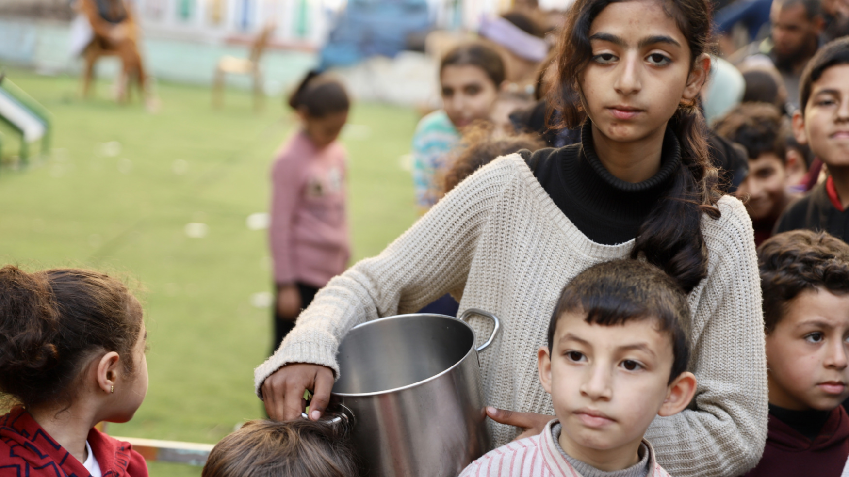 Children queue for food in Gaza City (Mohammed al-Hajjar/MEE)