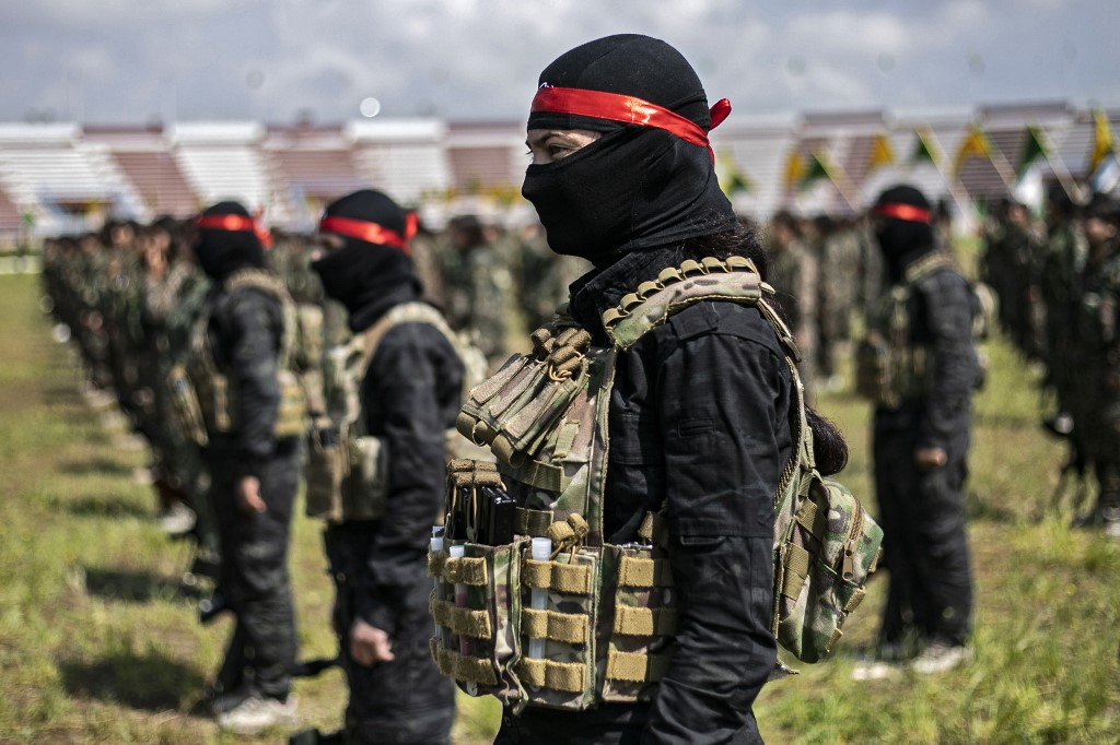 Kurdish fighters participate in a military parade in eastern Syria  on 27 March (AFP)