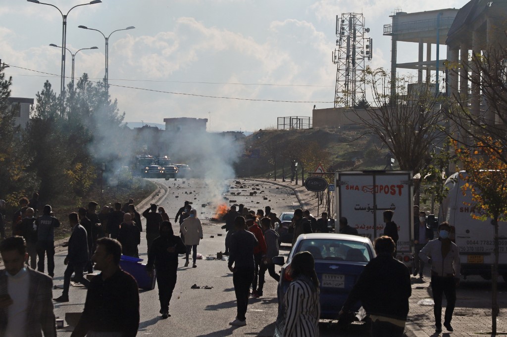 Iraqi Kurds block a boulevard outside a local government building during a protest against Kurdish authorities accused of corruption in Iraq's northeastern city of Sulaimaniyah on December 11, 2020