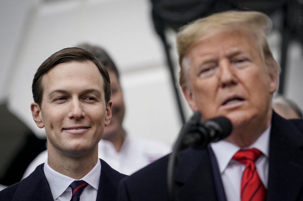 Adviser Jared Kushner looks on as US President Donald Trump speaks in Washington on 29 January (AFP)