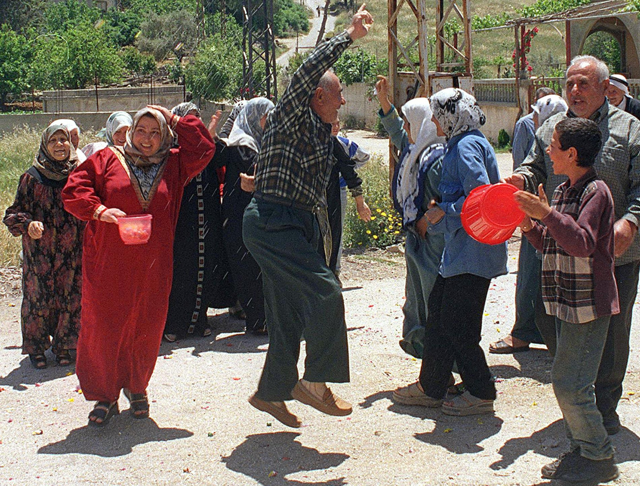 Lebanese celebrate in the southern Lebanese village of Adaisseh on 22 May 2000 after Israel's militia proxy South Lebanon Army (SLA) evacuated the village (AFP)