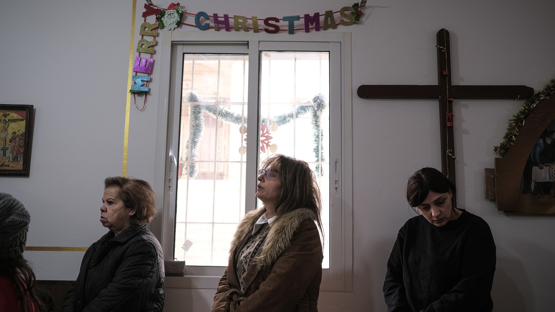 Worshippers attend Mass in a makeshift church in Derdghaya, 21 December (João Sousa/MEE)