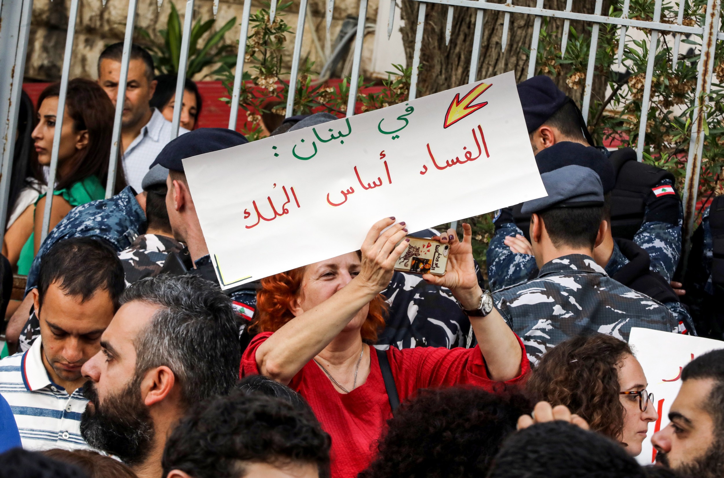 A Lebanese woman holds up a sign reading in Arabic 