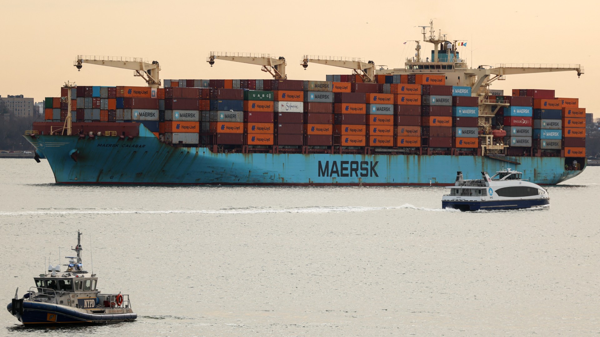 A Maersk cargo ship loaded with shipping containers navigates through New York Bay on 23 January 2026 (AFP/Charly Triballeau)
