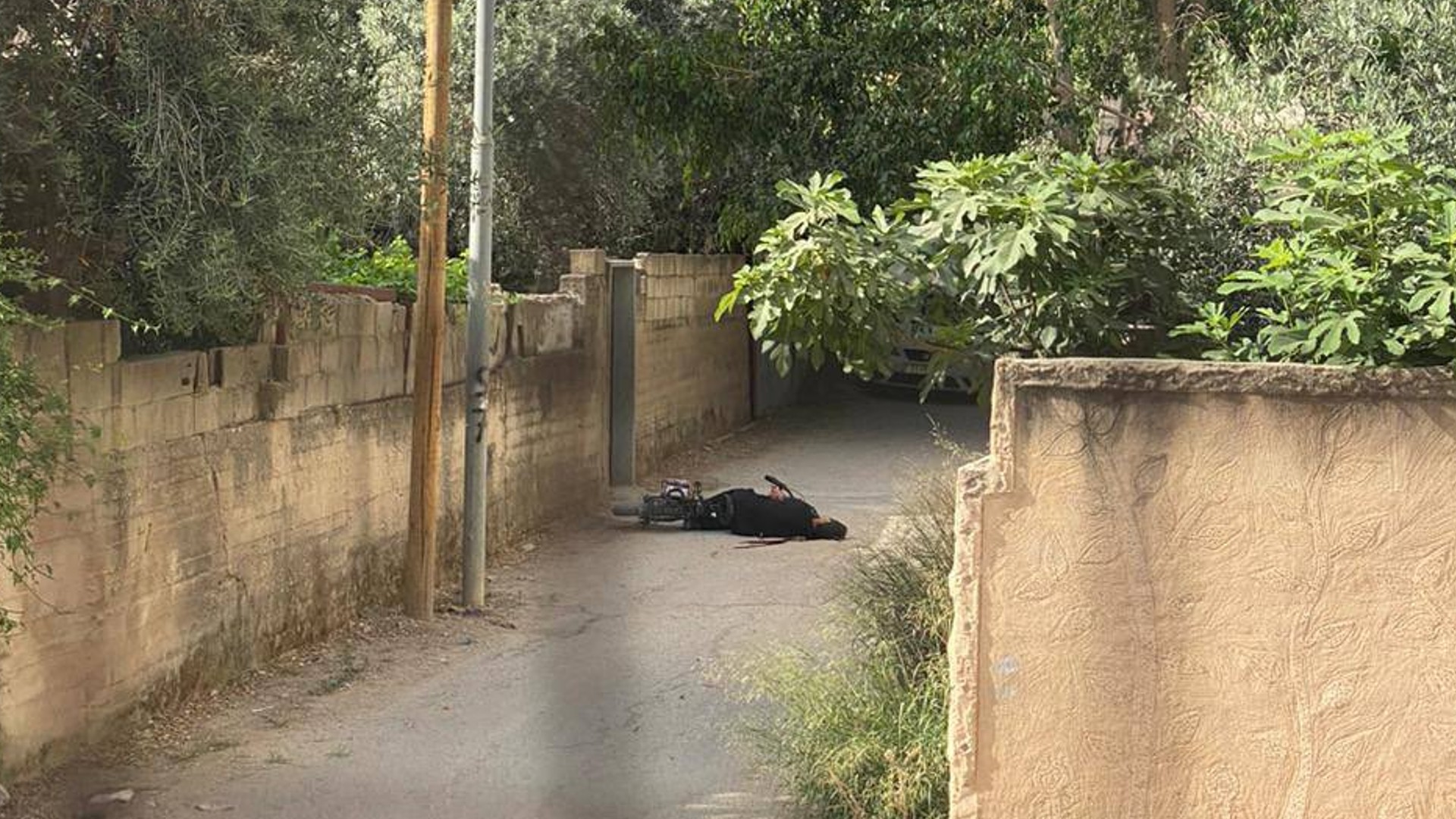 Photo of Mahmoud Hamadna laying next to his bicycle after being shot by an Israeli soldier in Jenin on 21 May 2024 (Social media)