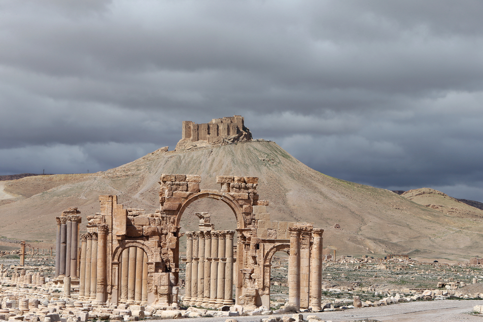 Palmyra's famous Arch of Triumph (front) and a partial view of the ancient oasis city, 215 km northeast of the Syrian capital, Damascus (AFP)
