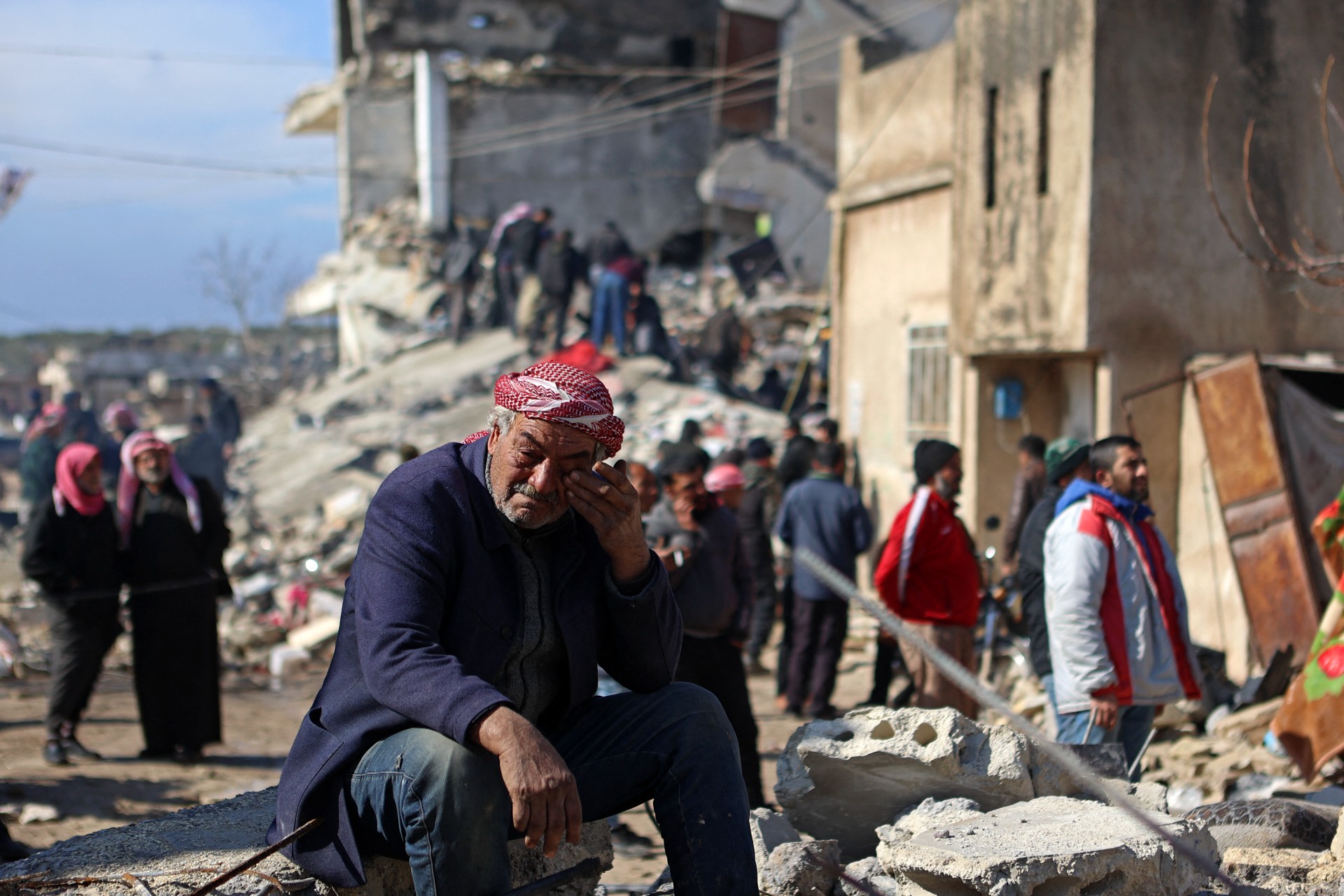 syrian man cries collapsed building 