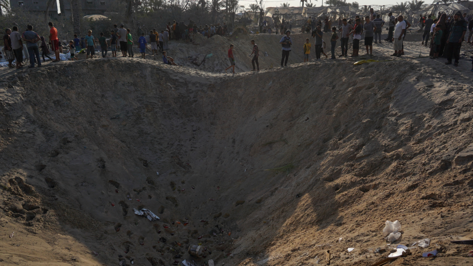 Palestinians inspect the damage at the site of the deadly Israeli strikes on al-Mawasi, southern Gaza, on 10 September 2024 (Bashar Taleb/AFP)