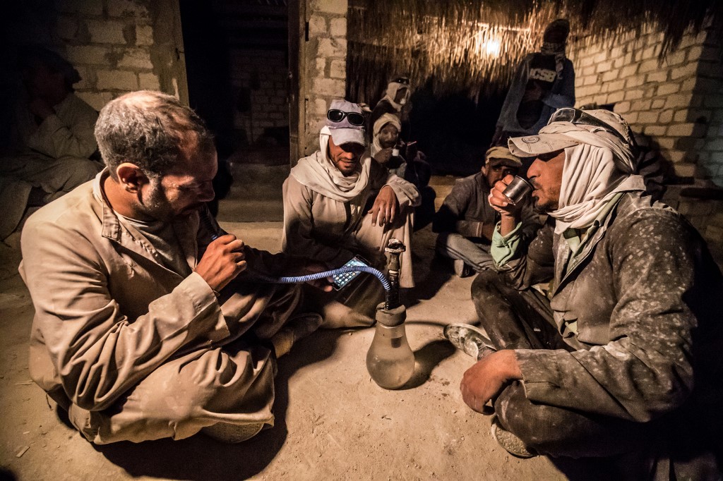 Labourers work at a quarry site near Minya, Egypt, on 7 December (AFP)