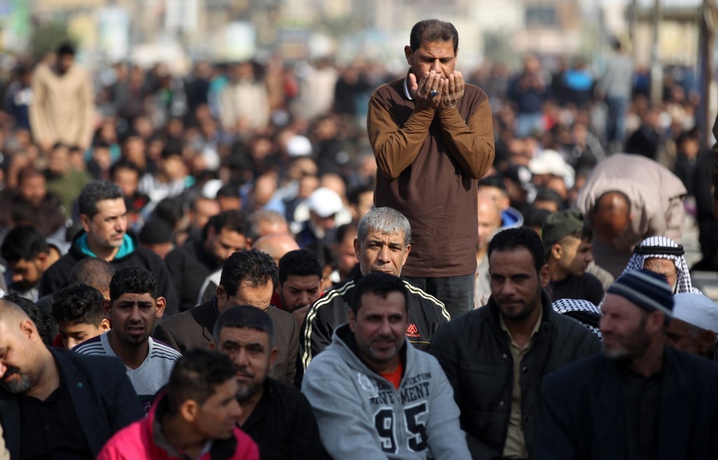 Supporters of Shiite cleric Moqtada al-Sadr take part in Friday prayers in the Sadr City suburb of the capital Baghdad, on January 3, 2020.