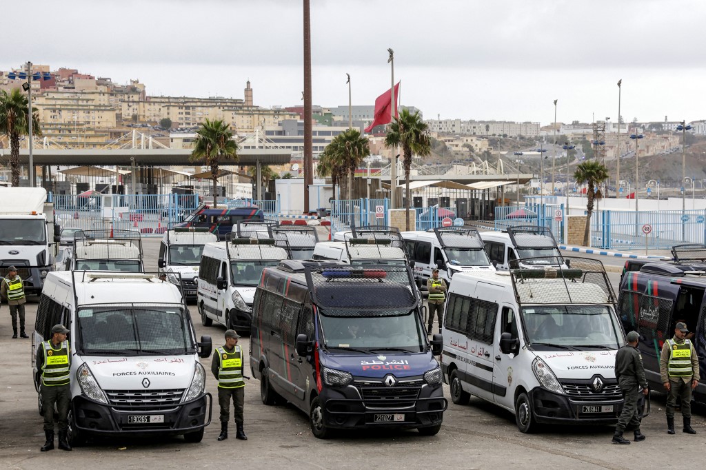 Vehicles of Morocco's law enforcement forces are deployed near the customs check-point along the land border with Ceuta in September (AFP)