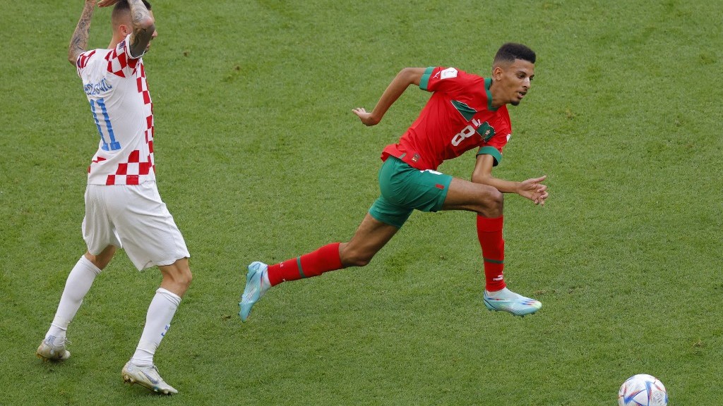 Moroccan midfielder Azzedine Ounahi (R) fights for the ball with Croatian midfielder Marcelo Brozovic (L) during the Group F football match on 23 November 2022 (AFP)