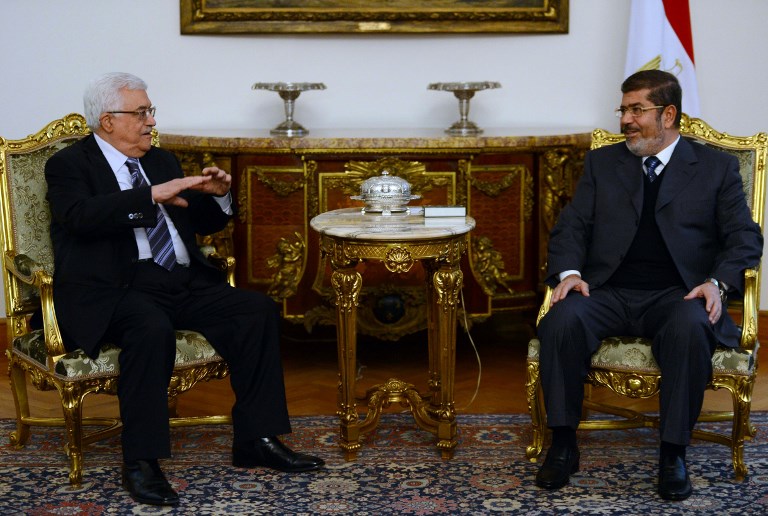 Former Egyptian President Mohamed Morsi meets Palestinian President Mahmoud Abbas in Cairo on 9 January 2013 (AFP)