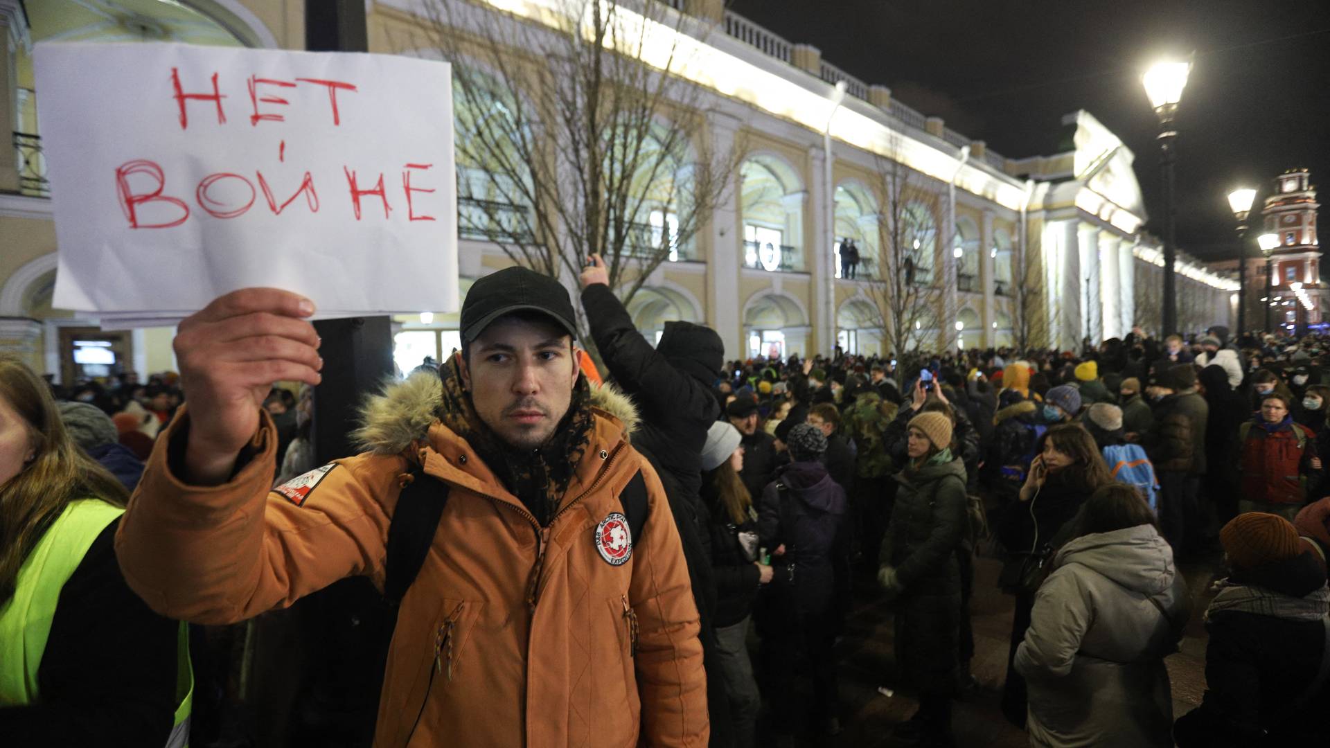 A demonstrator holding a placard reading 
