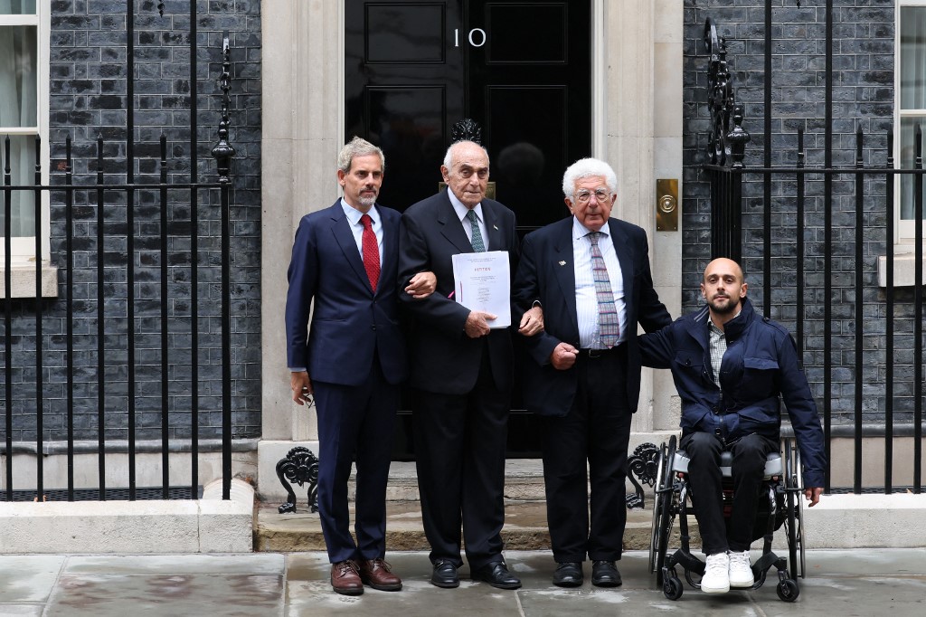 Campaigners including Munib al-Masri (CL) and Avi Shlaim (CR) pose while delivering a 