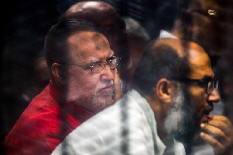 Muslim Brotherhood members attend their trial in Cairo on 2 December (AFP)