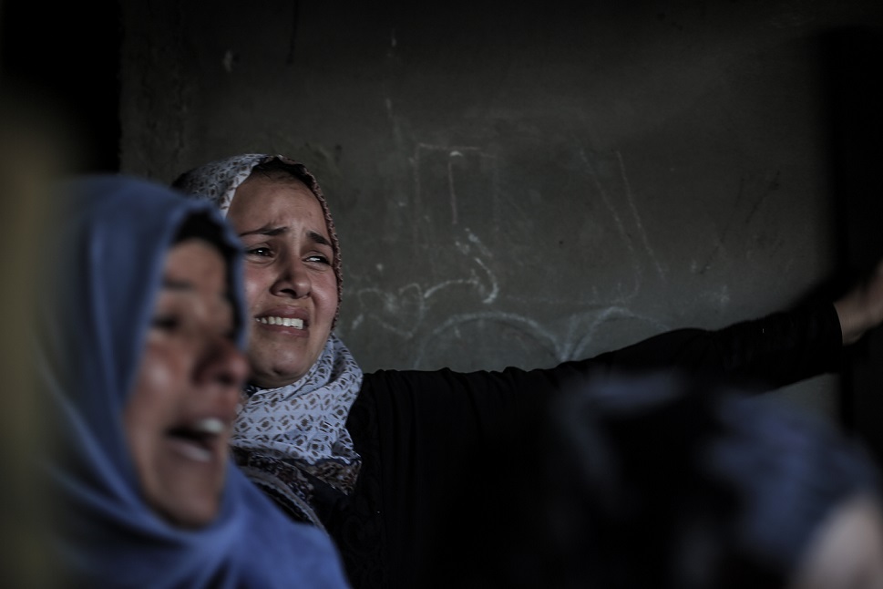 Relatives and friends mourn with Hala al-Najjar at her home (MEE/Sanad Abu Latifa)