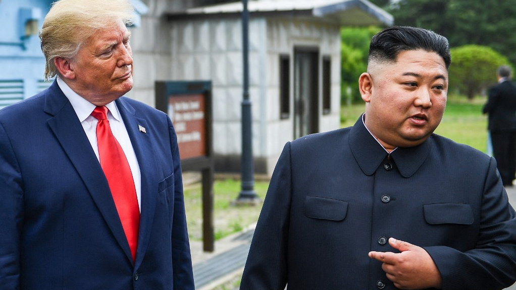 North Korean leader Kim Jong-un is pictured with US President Donald Trump in the Demilitarised Zone on 30 June 2019 (Brendan Smialowski/AFP)
