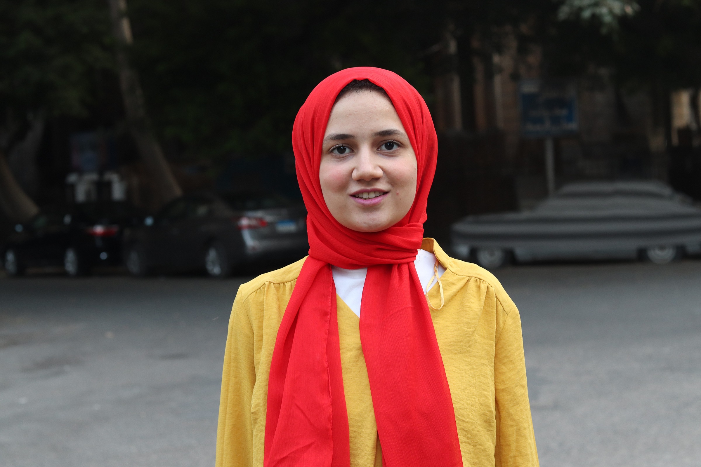 Nouran Farouk (right), one of the founders of Dosy, poses in Garden City, Cairo (MEE/AJ Naddaff)