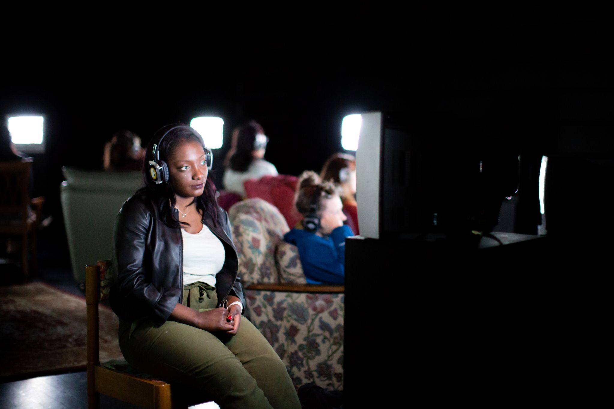 A member of the audience watches a television screen during Now is the Time to Say Nothing (credit)
