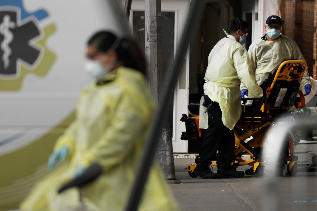 Medical workers admit patients at a coronavirus intake area in New York on 7 April (AFP)