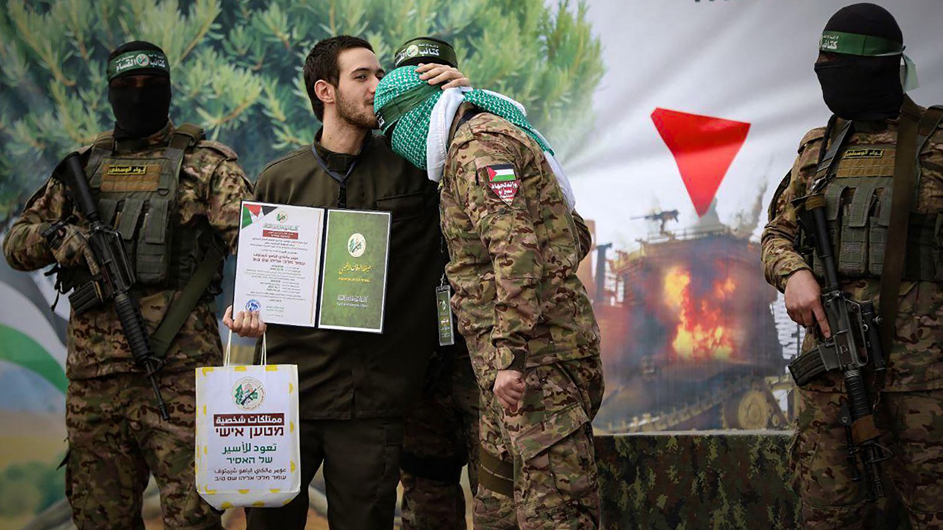 on February 22, 2025, shows newly-released Israeli hostage Omer Shem Tov kissing the head of a Hamas fighter shortly after being set free in Nuseirat in the central Gaza Strip