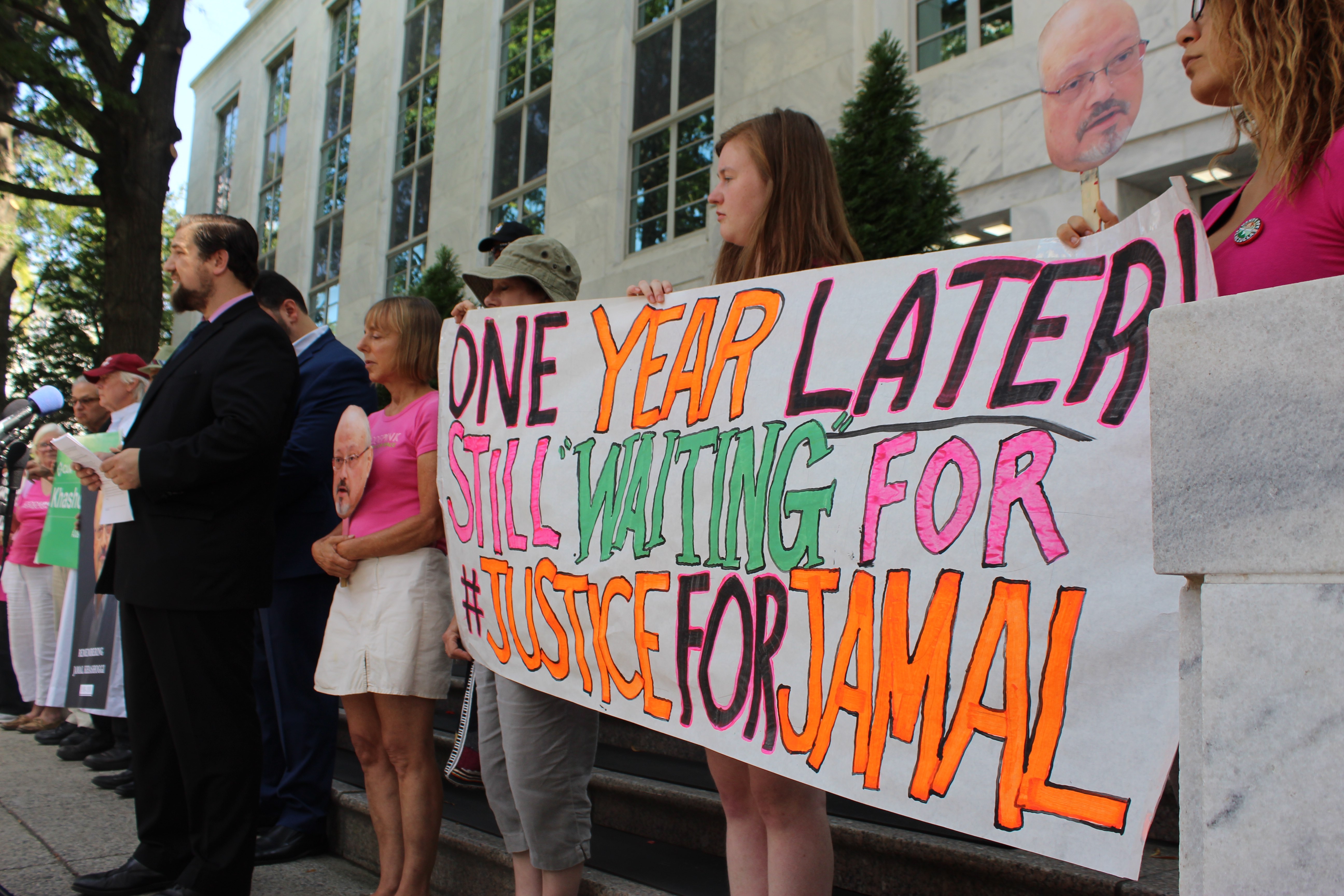 Protesters hold up a sign that reads: One year later, still 'waiting' for justice for Jamal during a press conference on 2 October 2019 (MEE/Sheren Khalel) 