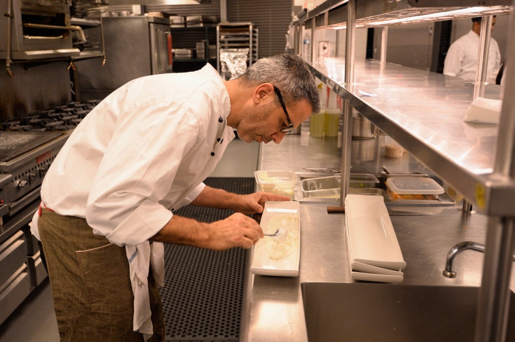 Chef Yotam Ottolenghi prepares food in New York City in 2014 (AFP)