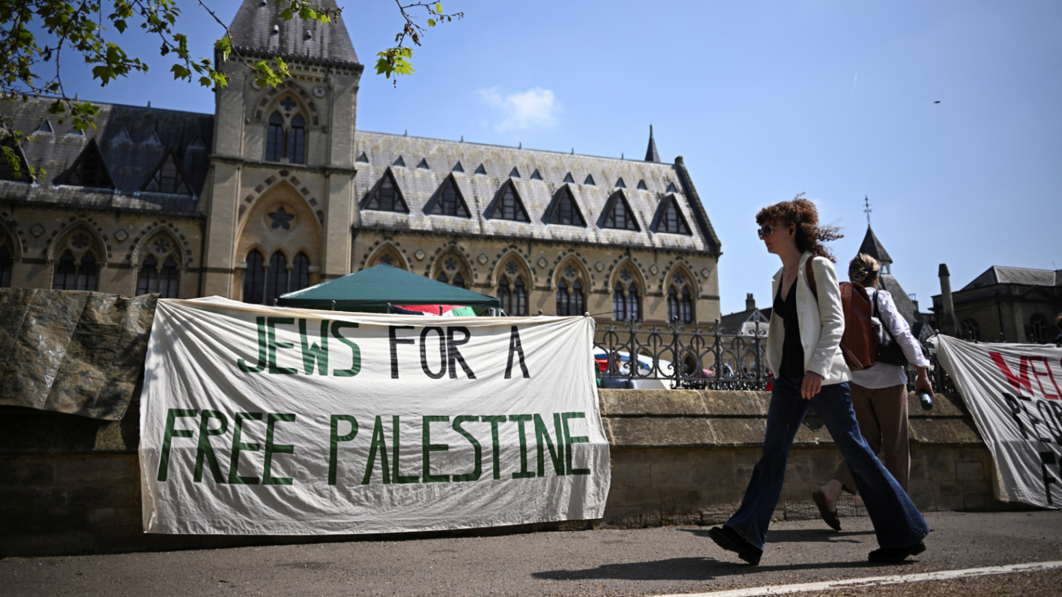 A pro-Palestine banner hangs in front of an encampment set up by students outside the Oxford University Museum of Natural History in Oxford, UK on 7 May 2024 (Dylan Martinez/Reuters)
