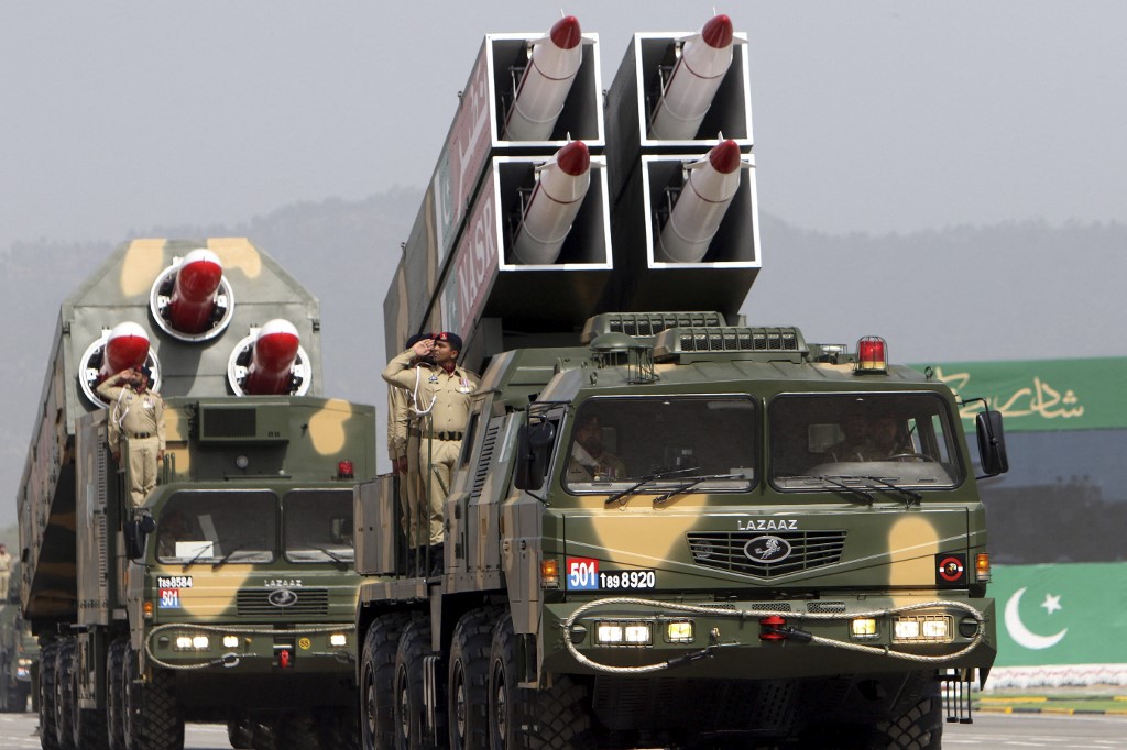 Pakistani soldiers salute during a military parade in Islamabad on 23 March 2022 (AFP)